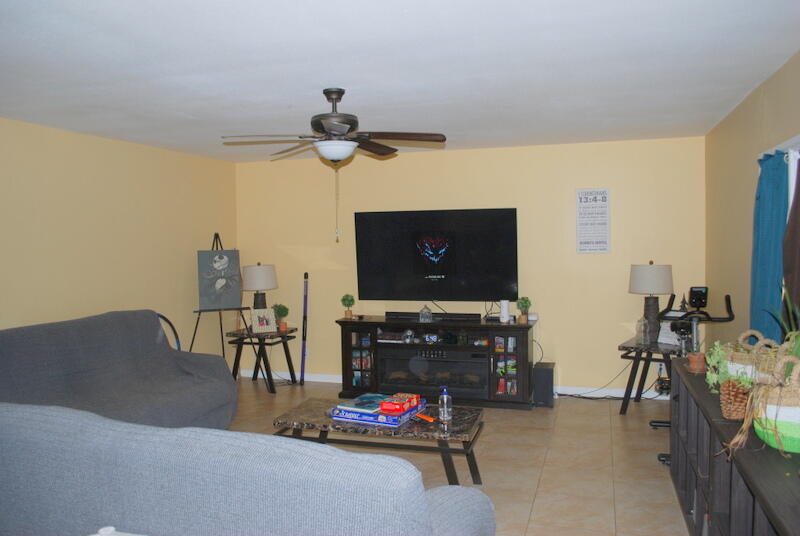 44561 Windsor Drive Indio, CA 92201 - Photo 18 of 22 a living room with furniture a flat screen tv and a fireplace