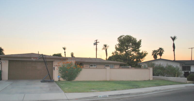 44561 Windsor Drive Indio, CA 92201 - Photo 20 of 22 a view of a white house with a yard and large tree