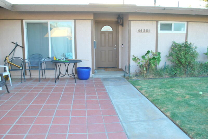 44561 Windsor Drive Indio, CA 92201 - Photo 3 of 22 a view of a porch with chairs and potted plants