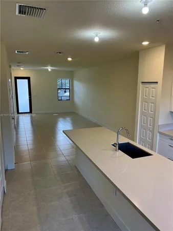 a view of a hallway with a desk and chair