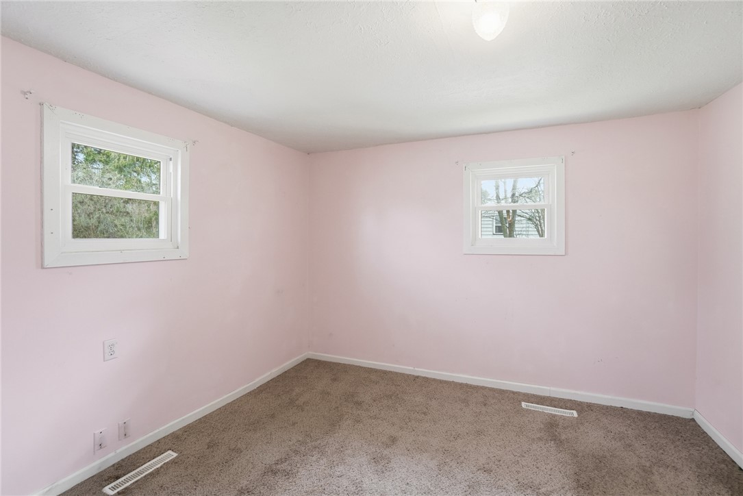 1166 West Sparrow Road Springfield, OH 45502 - Photo 30 of 40 This cozy bedroom features comfortable carpeting and ample natural light from two windows.