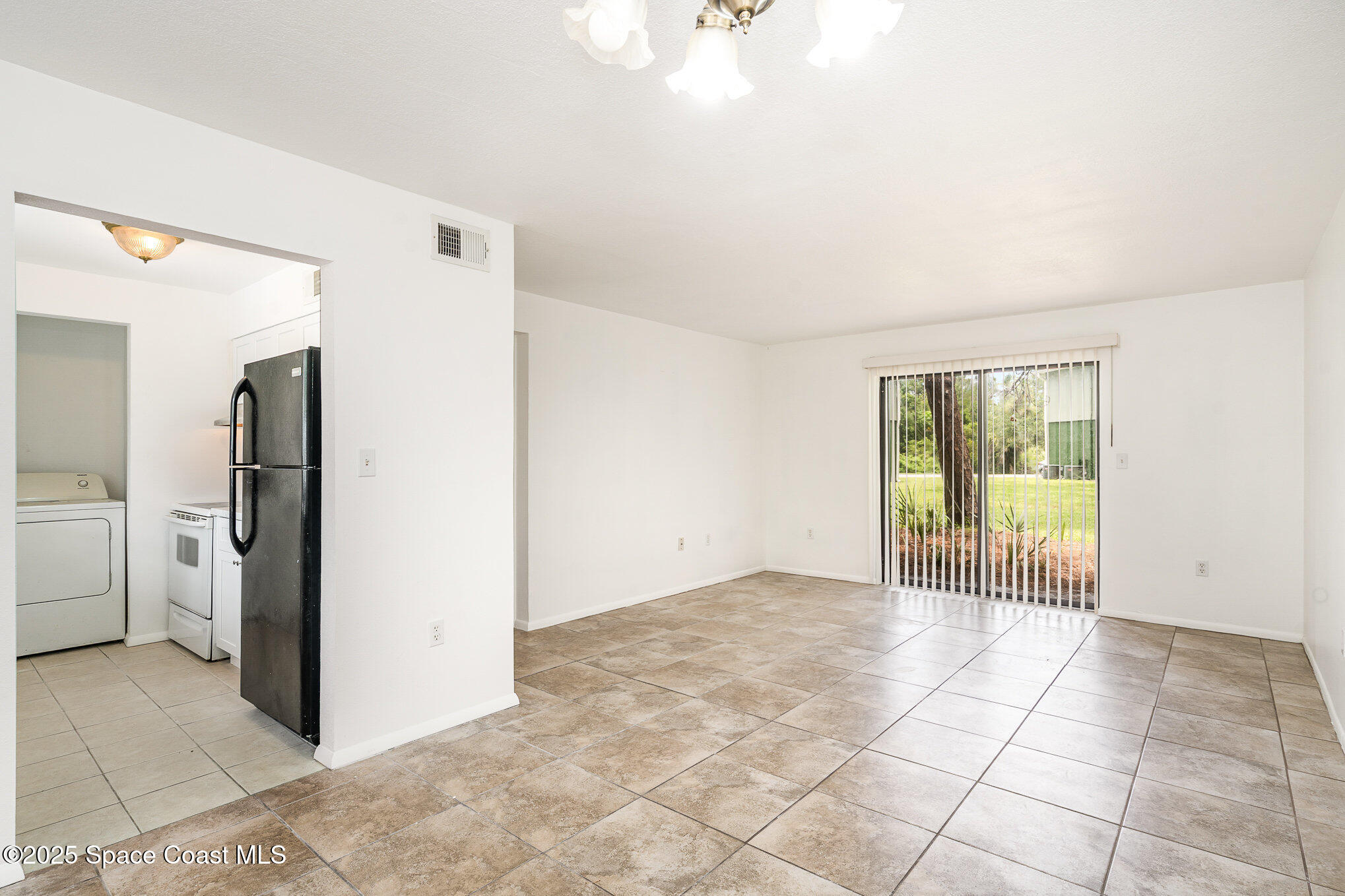 2219 Flower Tree Circle Melbourne, FL 32935 - Photo 12 of 26 a view of an empty room with a window
