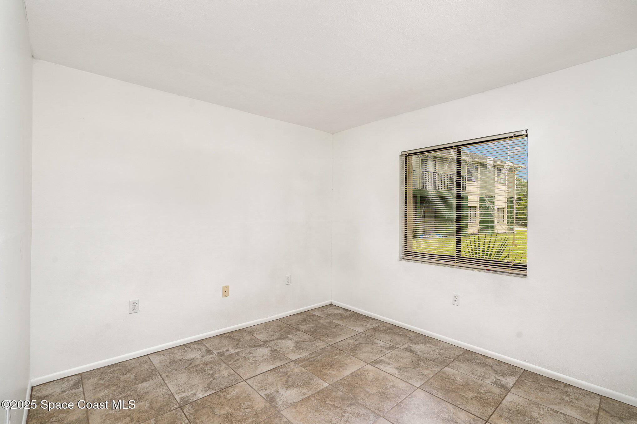 2219 Flower Tree Circle Melbourne, FL 32935 - Photo 17 of 26 an empty room with a window