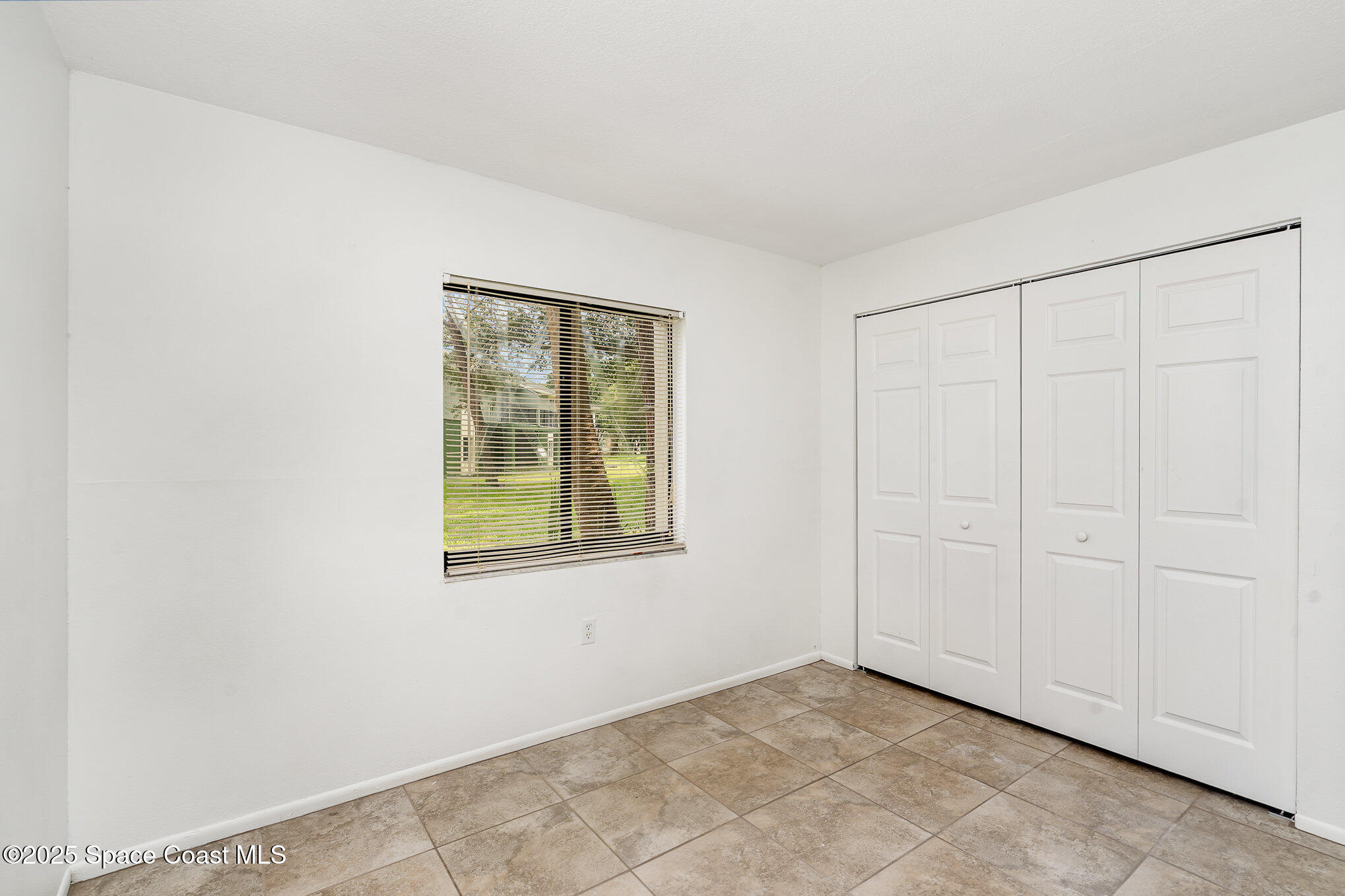 2219 Flower Tree Circle Melbourne, FL 32935 - Photo 19 of 26 an empty room with windows