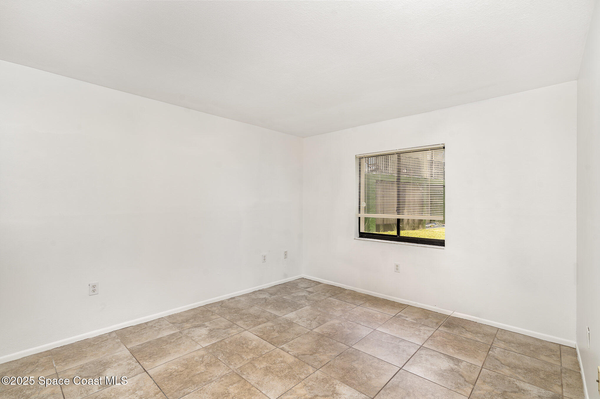 2219 Flower Tree Circle Melbourne, FL 32935 - Photo 21 of 26 an empty room with windows