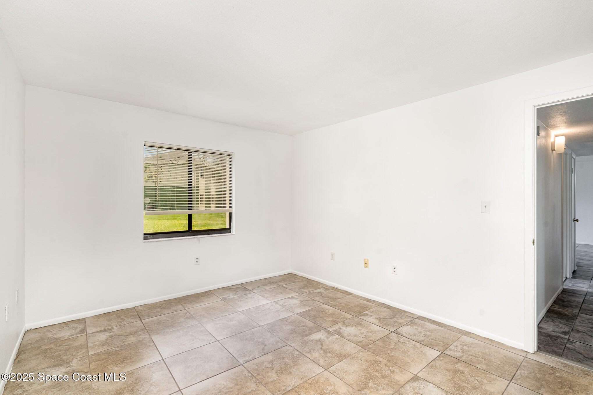 2219 Flower Tree Circle Melbourne, FL 32935 - Photo 22 of 26 a view of an empty room with a window
