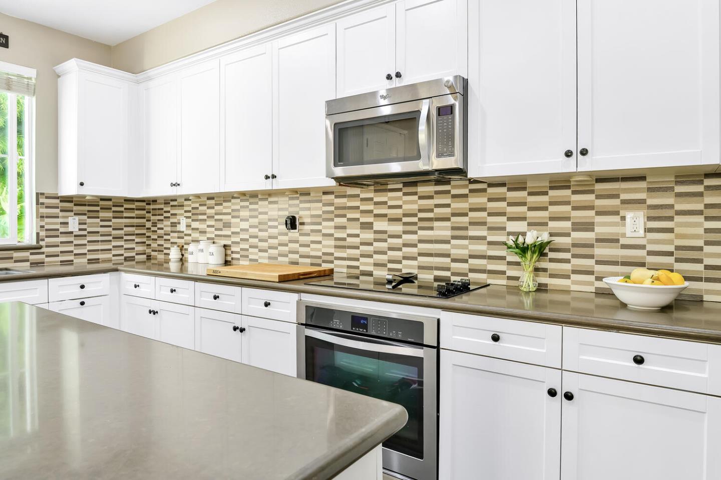 140 Larkspur Loop Morgan Hill, CA 95037 - Photo 12 of 28 a kitchen with granite countertop white cabinets stainless steel appliances a sink and a window