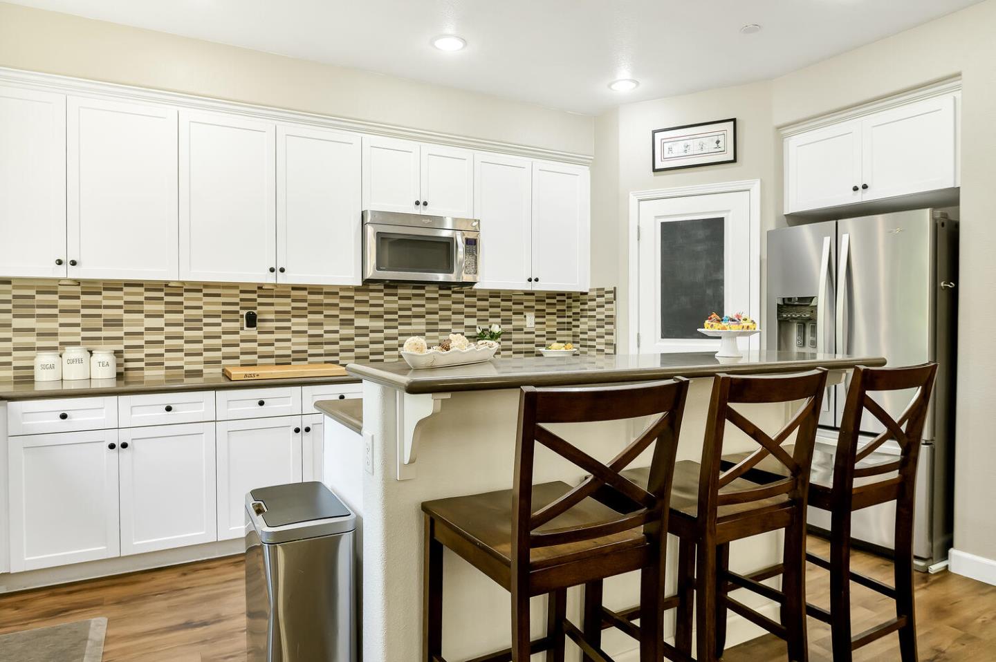 140 Larkspur Loop Morgan Hill, CA 95037 - Photo 10 of 28 a kitchen with stainless steel appliances granite countertop a stove top oven microwave and refrigerator