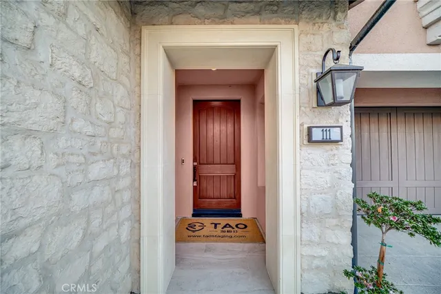 a living room with furniture kitchen view and a large window