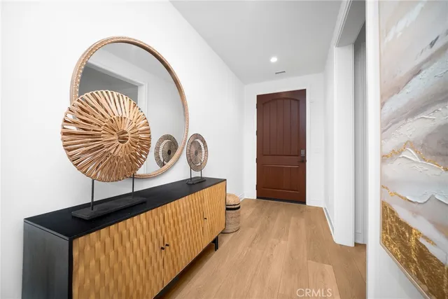 a living room with stainless steel appliances granite countertop furniture a fireplace a flat screen tv and a large window