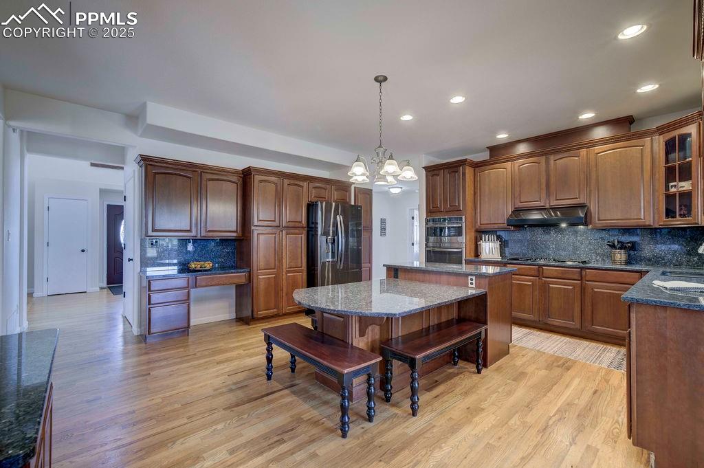 14650 Eastonville Road Elbert, CO 80106 - Photo 11 of 44 a large kitchen with kitchen island a island a sink a stove and a center island