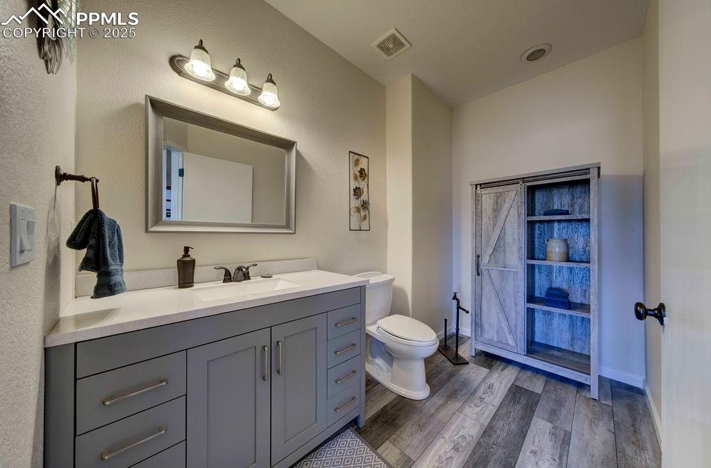 14650 Eastonville Road Elbert, CO 80106 - Photo 17 of 44 a bathroom with a toilet sink double vanity and mirror