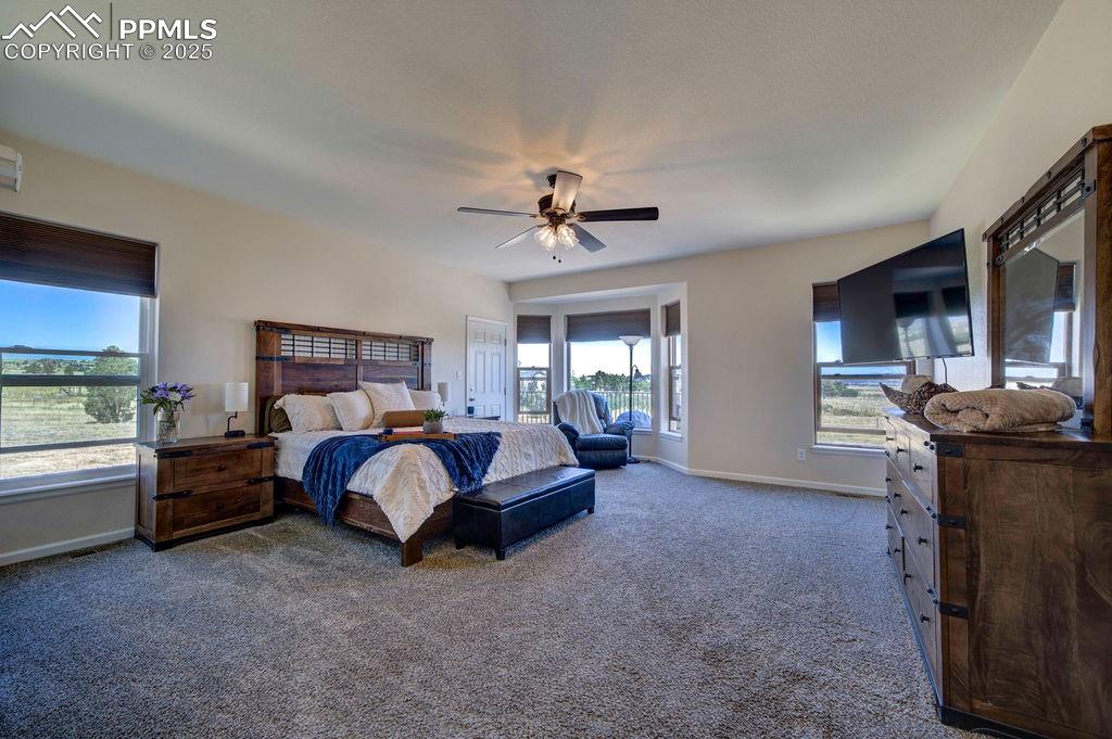 14650 Eastonville Road Elbert, CO 80106 - Photo 18 of 44 a bed room with furniture and a fireplace