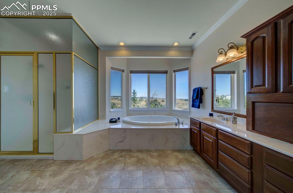 14650 Eastonville Road Elbert, CO 80106 - Photo 21 of 44 a large spacious bathroom with a large tub shower and sink