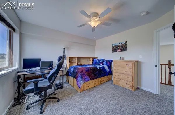 a bedroom with furniture and a window