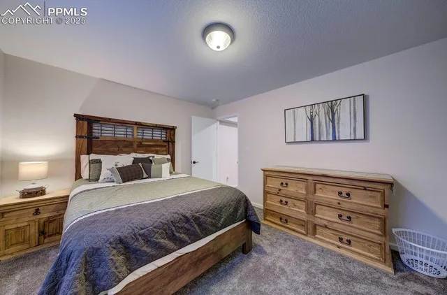 a kitchen with stainless steel appliances a table chairs in it and wooden floors