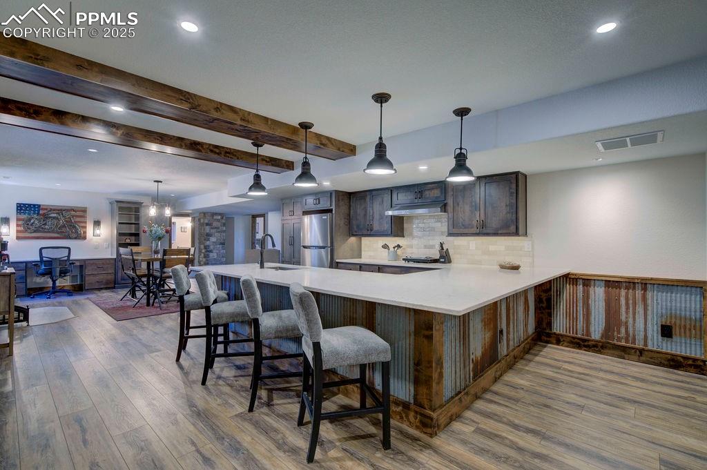 14650 Eastonville Road Elbert, CO 80106 - Photo 31 of 44 a kitchen with stainless steel appliances a table chairs in it and wooden floors