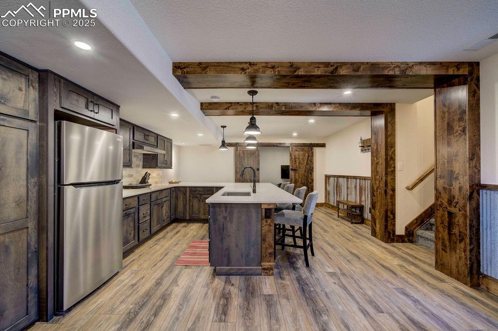 14650 Eastonville Road Elbert, CO 80106 - Photo 32 of 44 a kitchen with stainless steel appliances a dining table chairs refrigerator and sink