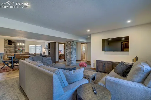 a living room with furniture and a wooden floor
