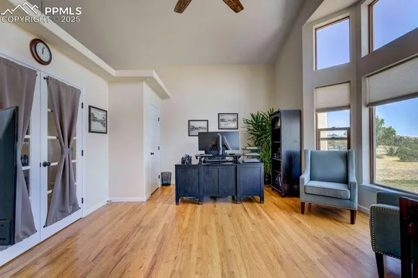 a kitchen with stainless steel appliances granite countertop a refrigerator a sink dishwasher a dining table and chairs with wooden floor