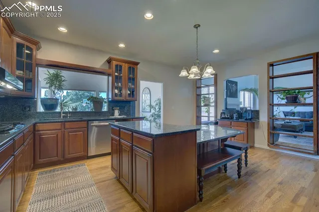 a kitchen with stainless steel appliances granite countertop a sink and cabinets