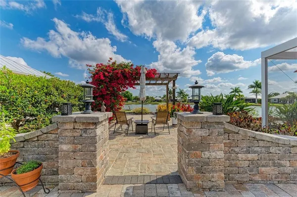 an aerial view of a house with outdoor space and lake view in back