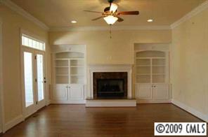 785 Revival Row Fort Mill, SC 29708 - Photo 4 of 8 an empty room with windows and fireplace