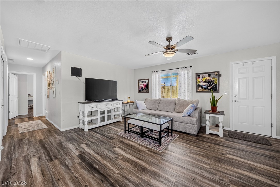 2970 Rio Rico Drive Pahrump, NV 89048 - Photo 12 of 41 Rich wood-look flooring and smooth plaster walls anchor this welcoming, open-concept living area.