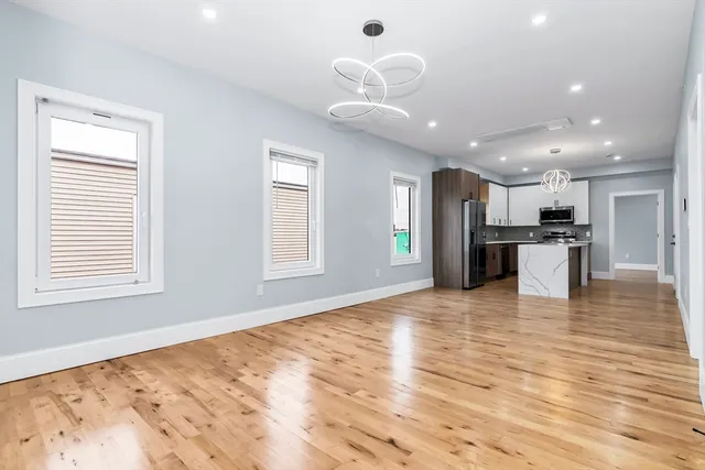 a view of kitchen with refrigerator and window