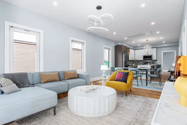 a living room with furniture kitchen and a table