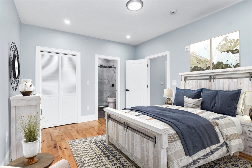 50 Maverick Street, Unit 3 Chelsea, MA 02150 - Photo 17 of 24 a bedroom with a bed and a couch