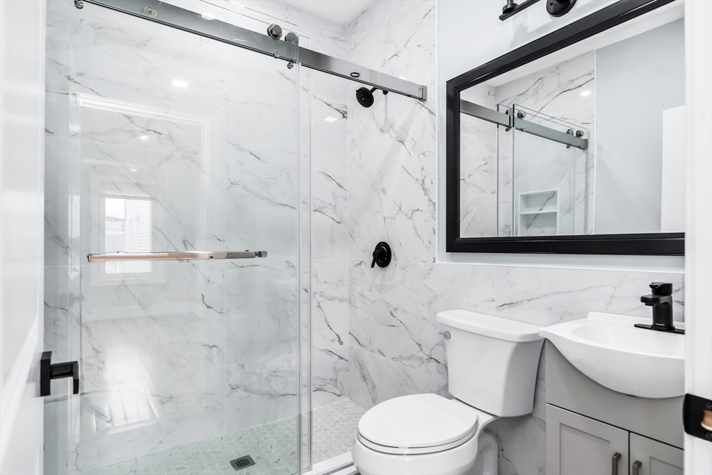 50 Maverick Street, Unit 3 Chelsea, MA 02150 - Photo 19 of 24 a white toilet sitting next to a bathroom sink