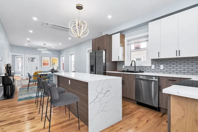 a large kitchen with lots of counter space a sink appliances and dining table