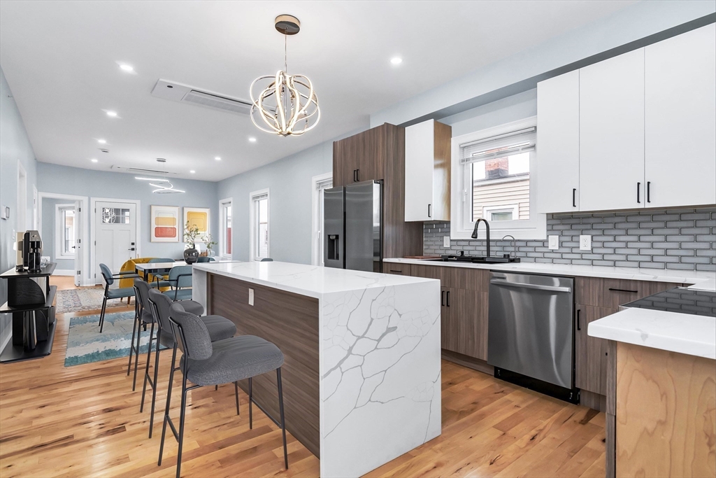 50 Maverick Street, Unit 3 Chelsea, MA 02150 - Photo 2 of 24 a large kitchen with lots of counter space a sink appliances and dining table