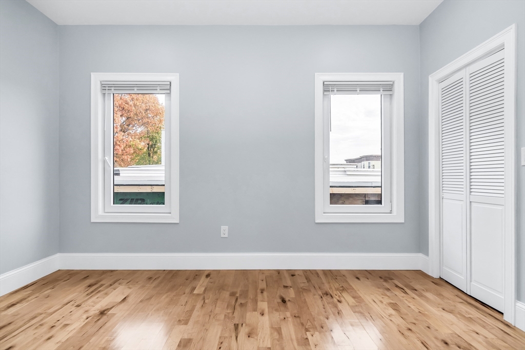 50 Maverick Street, Unit 3 Chelsea, MA 02150 - Photo 21 of 24 a view of an empty room with wooden floor and a window