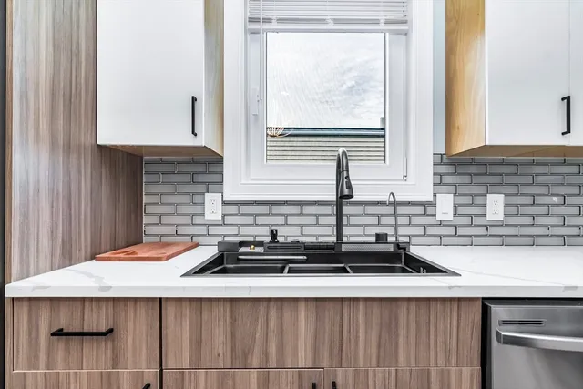 a kitchen with a sink and a window