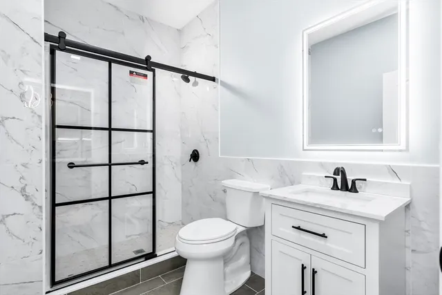 a bathroom with a sink toilet and shower