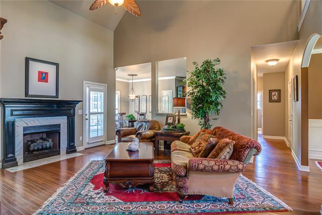 133 Ridgeview Trace Hendersonville, TN 37075 - Photo 5 of 20 Large open family room with hardwoods features custom 72" Banana Leaf fan and stained fireplace.