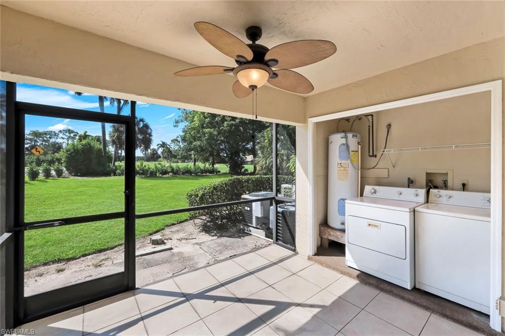 5857 Rattlesnake Hammock Road, Unit 101 Naples, FL 34113 - Photo 16 of 19 Screened patio featuring a ceiling fan, tile flooring, and integrated laundry area with hookups and water heater