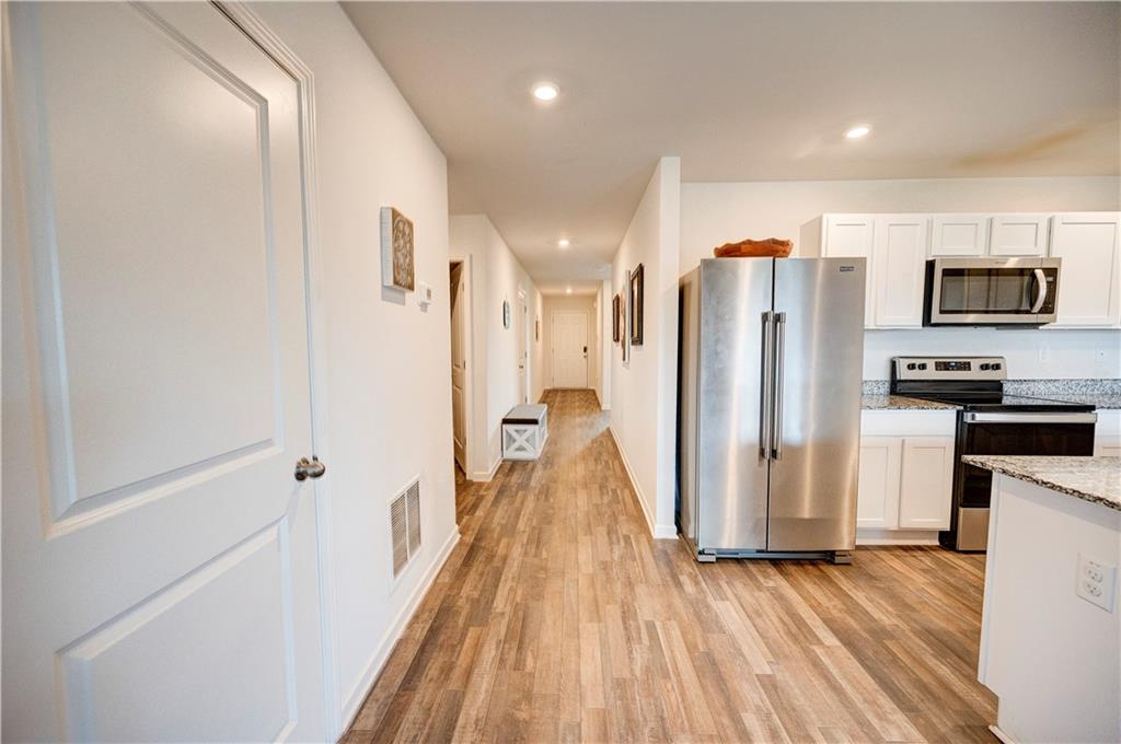 500 Pemberton Street Kingston, GA 30145 - Photo 17 of 46 a view of a kitchen with wooden floor and electronic appliances