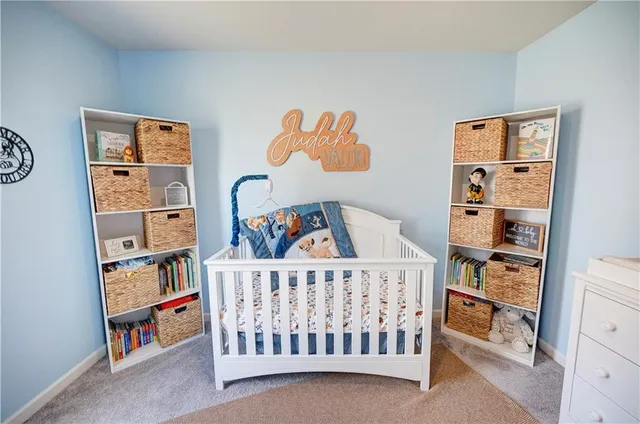 a bedroom with baby crib and book shelf