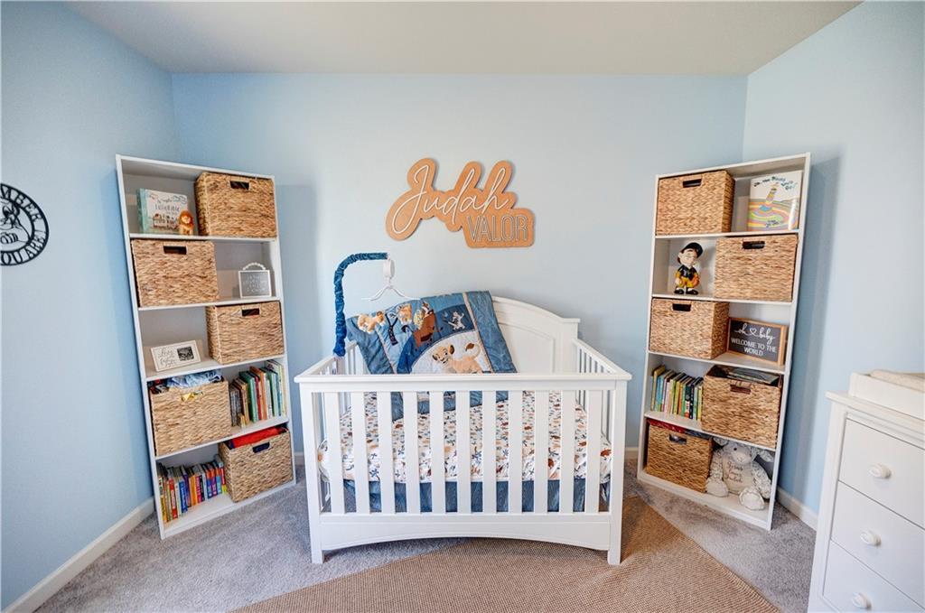 500 Pemberton Street Kingston, GA 30145 - Photo 21 of 46 a bedroom with baby crib and book shelf