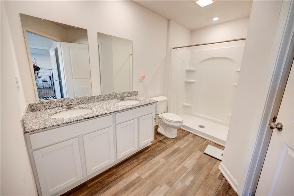 500 Pemberton Street Kingston, GA 30145 - Photo 28 of 46 a spacious bathroom with a granite countertop sink a toilet and a shower