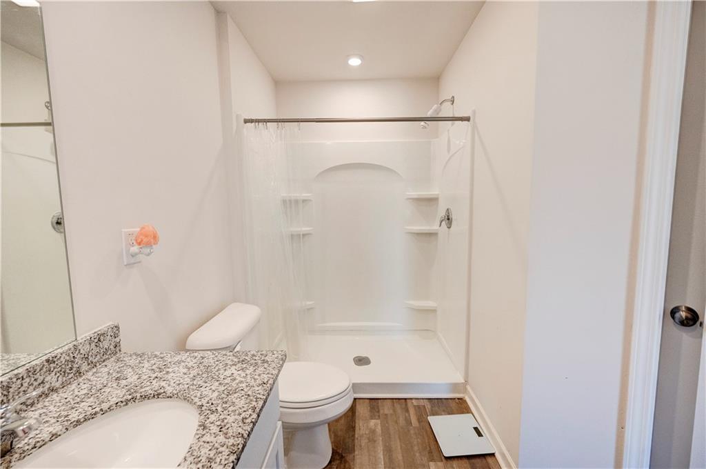 500 Pemberton Street Kingston, GA 30145 - Photo 29 of 46 a bathroom with a granite countertop sink toilet and shower