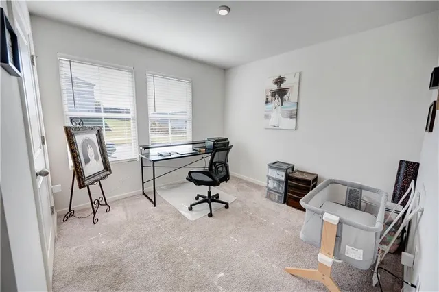 a view of a workspace with furniture and a window