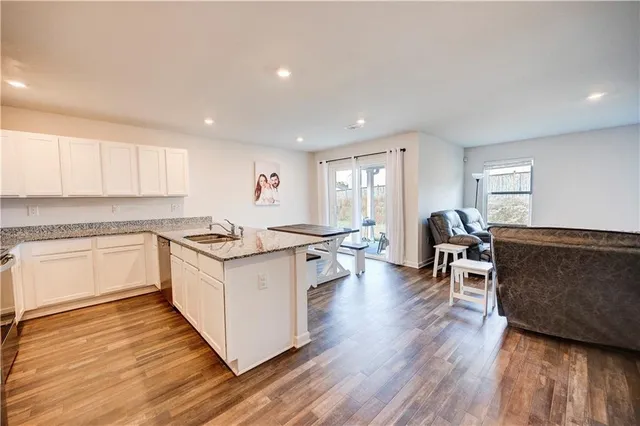 a open kitchen with white cabinets and white appliances