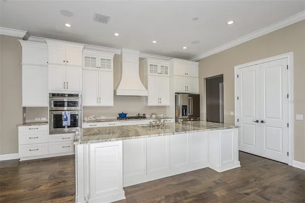 a kitchen with stainless steel appliances granite countertop a sink and cabinets