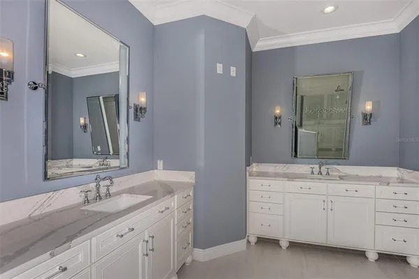 a bathroom with a granite countertop sink double and mirror
