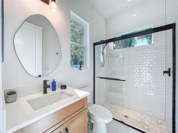 a bathroom with a sink toilet and a mirror