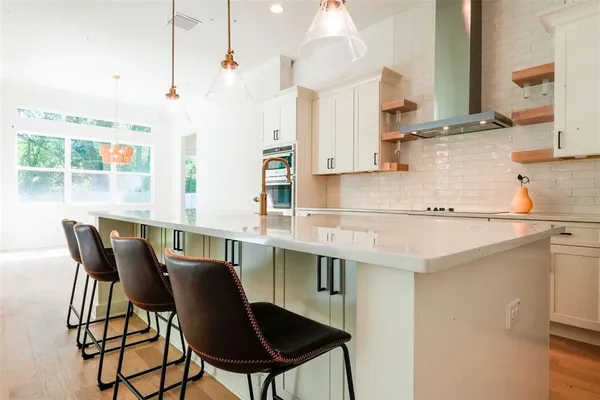 a kitchen with a dining table chairs and sink